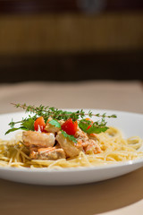 Image of tasty pasta with salmon and herbs