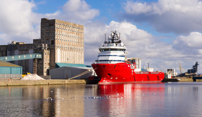 Large red cargo ship in Edinburgh docks.