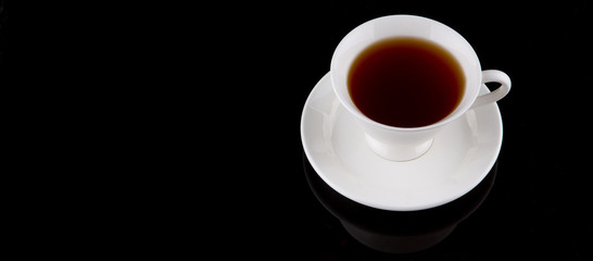 A cup of tea over black background