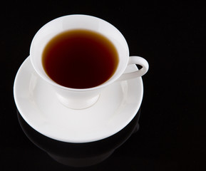 A cup of tea over black background