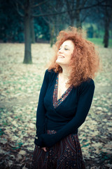 Naklejka premium young beautiful red curly hair woman