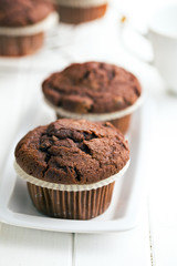 chocolate muffins on white table