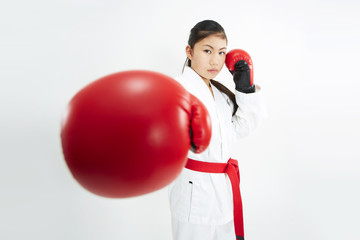 young taekwondo girl with red boxing glove