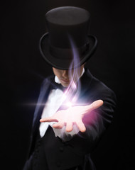 magician holding something on palm of his hand - obrazy, fototapety, plakaty