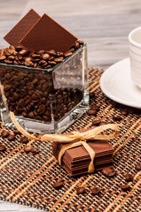 Chocolate and coffee beans on a bamboo mat