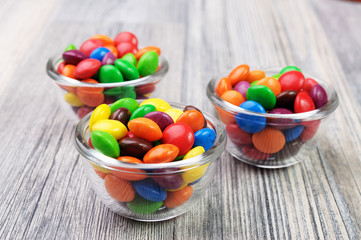 Colorful candies in glass bowls