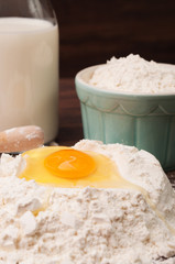 A hill of flour with yolk and egg white
