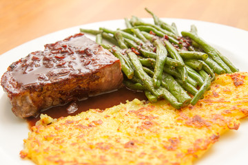 steak with potatao fritter and beans