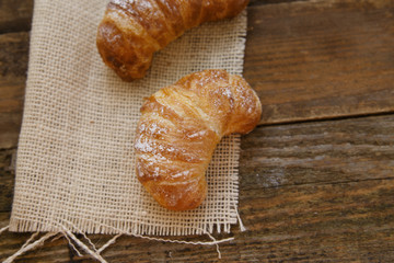 Two croissants on a linen cloth