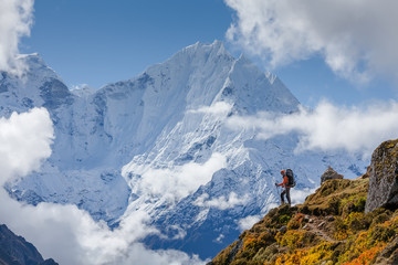 Hiker walks on train in Himalayas - obrazy, fototapety, plakaty
