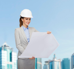 smiling architect in white helmet with blueprints