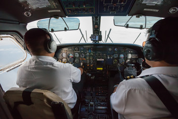 Two pilots inside propeller plane © Maygutyak
