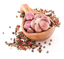 Garlic cloves in wooden bowl isolated on white background