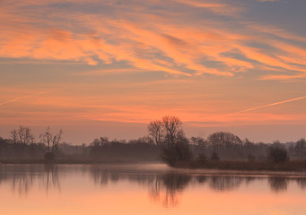 Sun rising at a small pond in Holland.