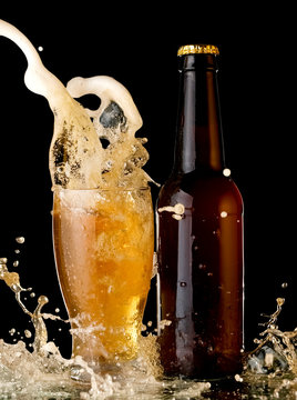 Beer Glass And Bottle Up And Splash