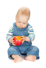 Fototapeta na wymiar Small baby boy holding an apple