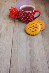 Fototapeta na wymiar Tea cup and cookies over wooden table