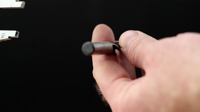A caliper getting the measurement of the screw