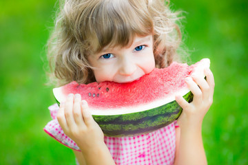 Happy child eating watermelon