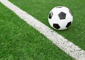 Traditional soccer ball on soccer field © Mariusz Blach