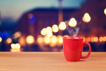 Red cup over city bokeh background