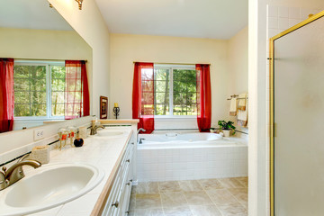 Cozy ivory bathroom with a french window and red curtains
