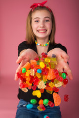 Young girl in a pool of colorful candy