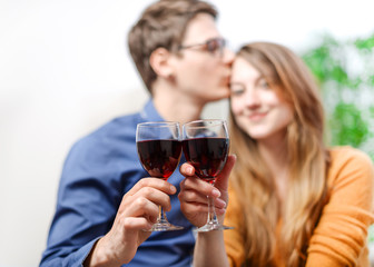 Very beautiful young couple toasting wine glasses