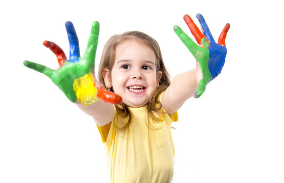 happy little girl with hands painted in vivid colours