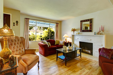 Living room with a brick background fireplace and antique chair