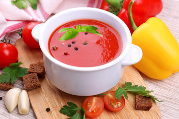 Tasty tomato soup and vegetables, close up