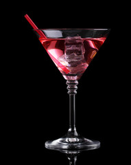 Red cocktail in martini glass isolated on black