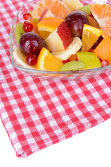 Sweet fresh fruits in bowl on table close-up