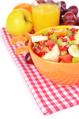 Sweet fresh fruits in bowl on table close-up