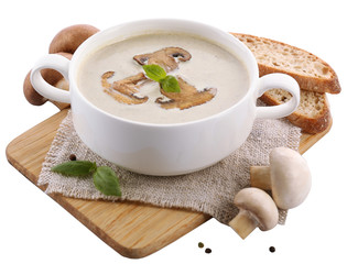 Mushroom soup in white bowl, on napkin, isolated on white