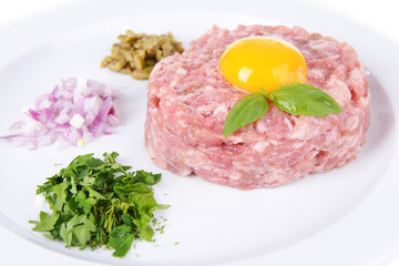 Delicious steak tartare with yolk on plate close-up