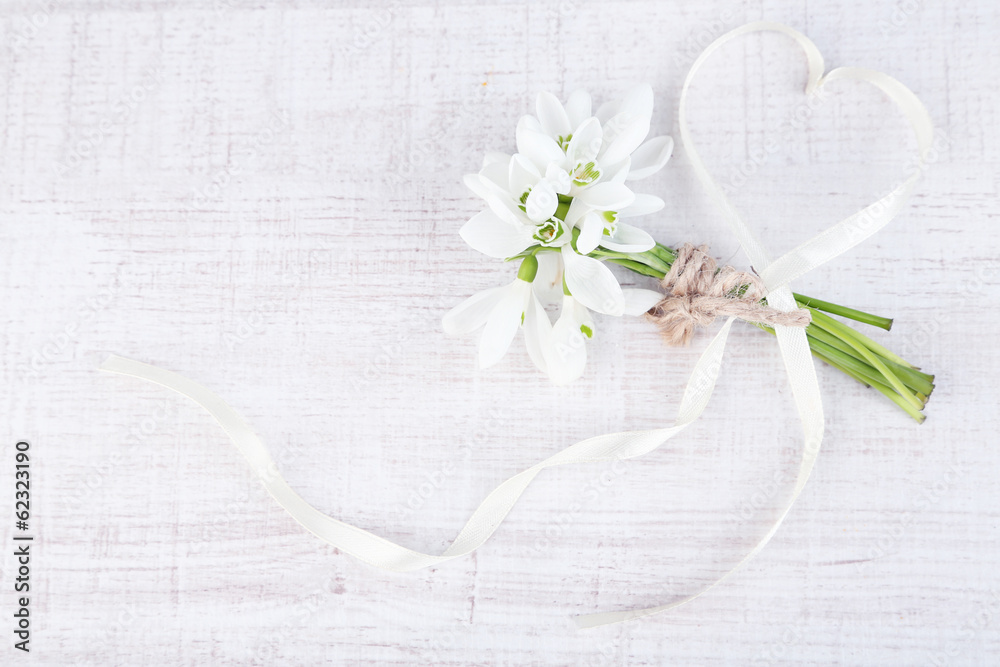 Poster Bouquet of beautiful snowdrops on wooden background