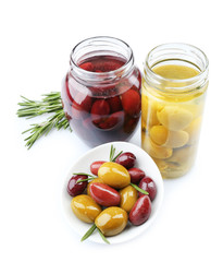 Tasty olives in glass jars, isolated on white