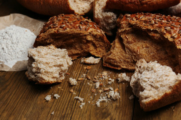 Breaking bread on wooden table