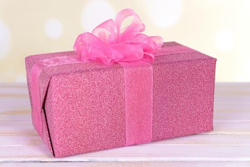 Gift box on table on light background