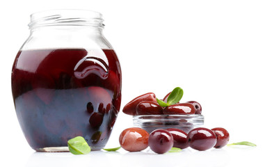 Black olives in glass jar, isolated on white