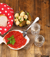 Composition with glass of vodka and marinated mushrooms,