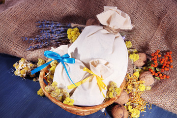 Textile sachet pouches with dried flowers, herbs and berries