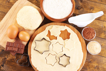 Making cookies on wooden background