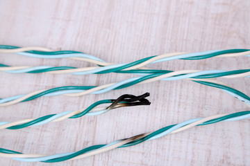 Short circuit, burnt cable, on color wooden background