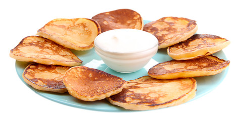 Fried pancakes on color plate, isolated on white