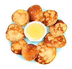 Fried pancakes on color plate, isolated on white