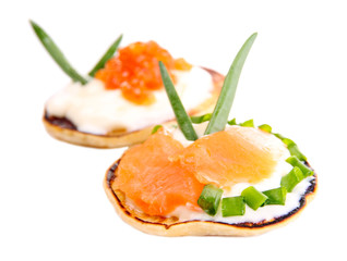 Pancakes with red caviar and salmon,  isolated on white