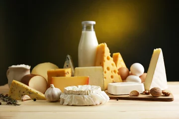 Foto auf Leinwand Tasty dairy products on wooden table, on dark background © Africa Studio