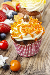 Beautiful cupcakes decorated with orange sprinkles